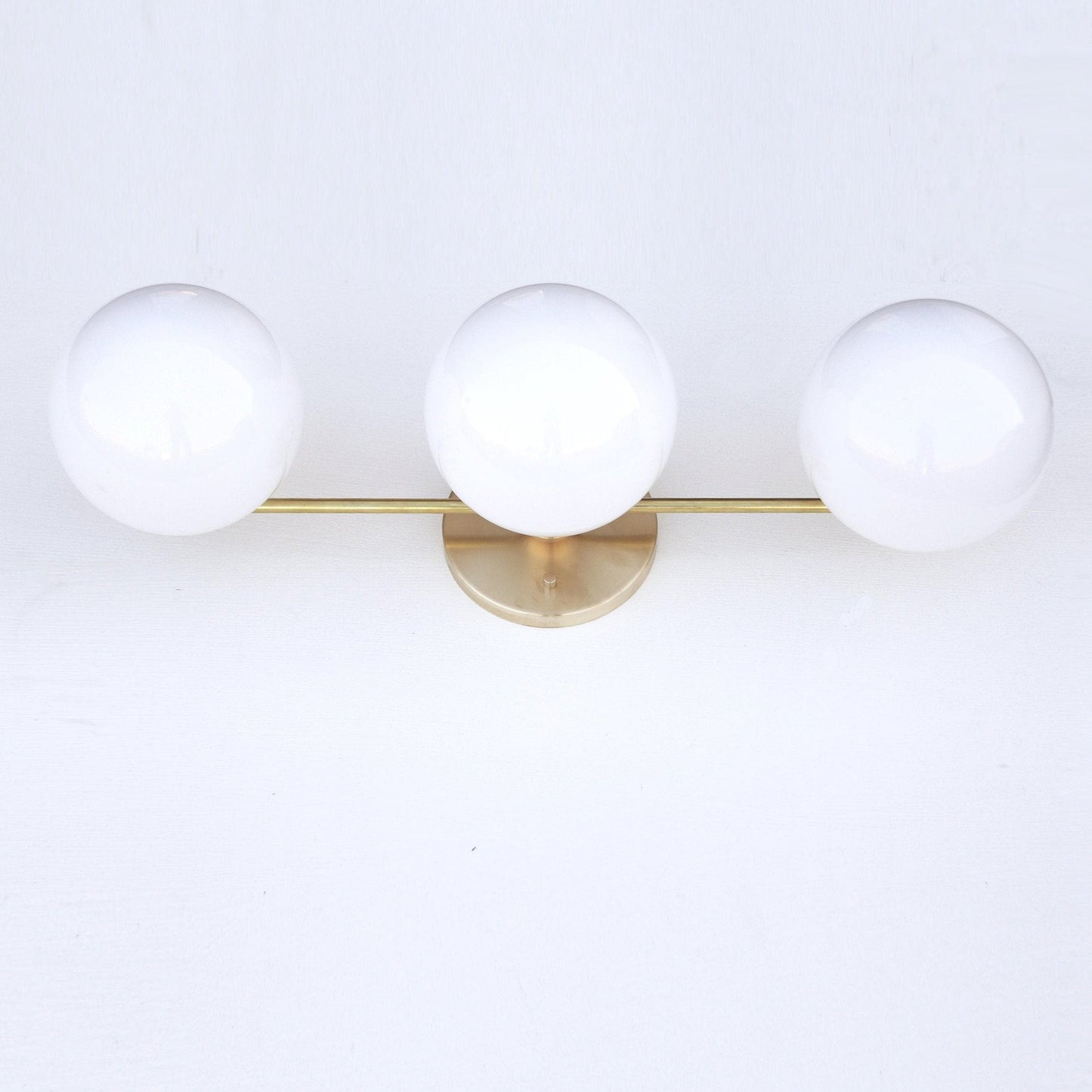 Wide Three-Light Brass Vanity Sconce with Six-Inch Opal Globes