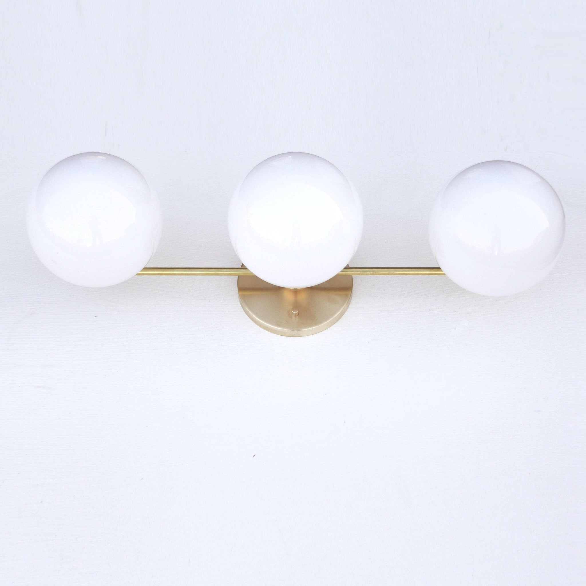 Wide Three-Light Brass Vanity Sconce with Six-Inch Opal Globes